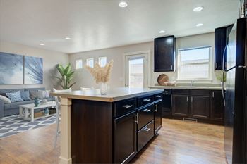 a kitchen with a large center island and black cabinets at Copper Pines, Bozeman, MT, 59718